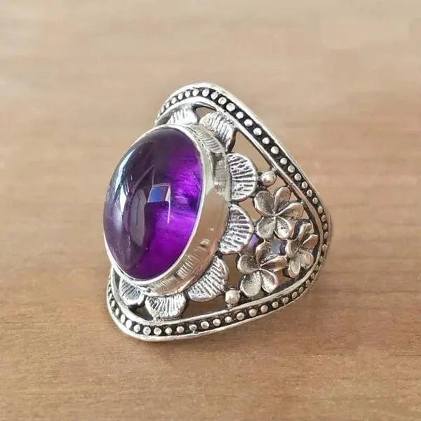 Anello con fiore e pietra preziosa viola