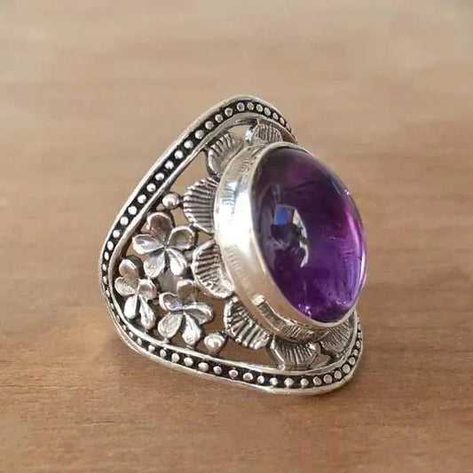 Anello con fiore e pietra preziosa viola