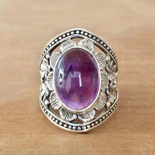 Anello con fiore e pietra preziosa viola