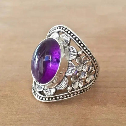 Anello con fiore e pietra preziosa viola