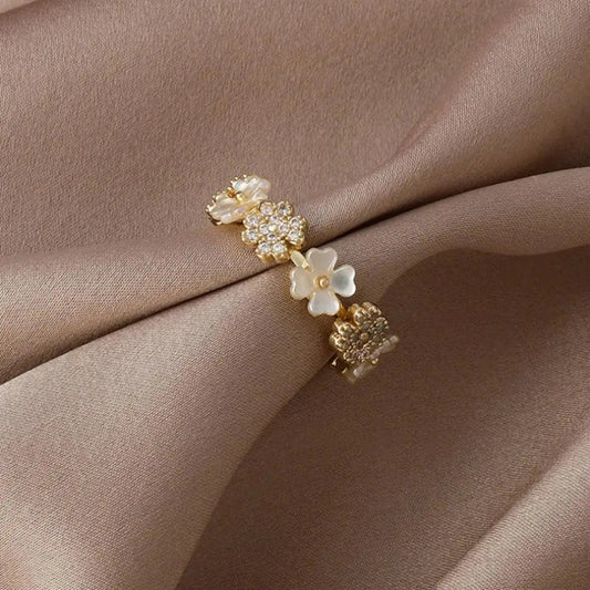 Anello regolabile in oro con fiori bianchi e zirconi