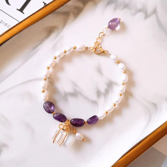 Braccialetto con pietre viola e perle in oro